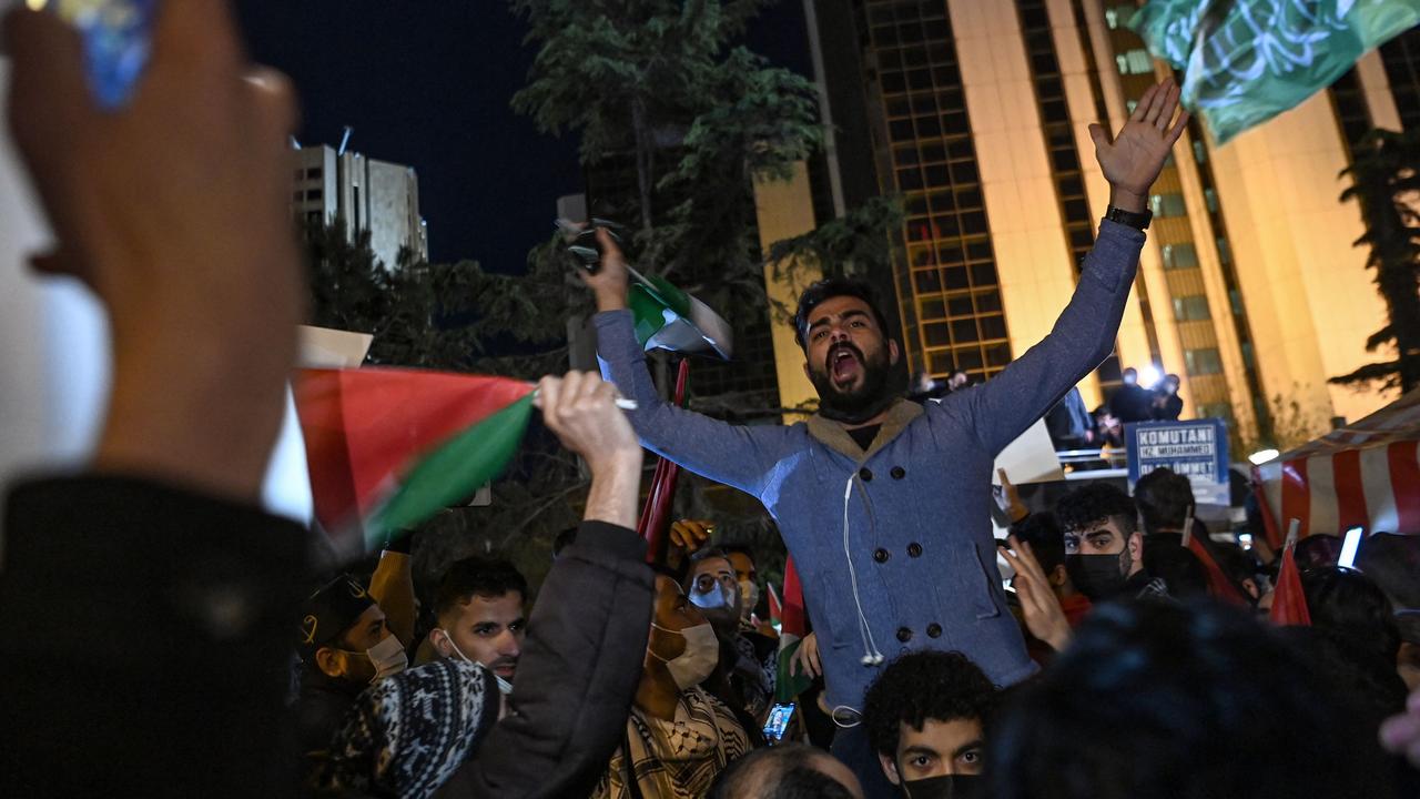 Protesters hold Palestine and Turkish national flags and chant slogans during a protest against Israel in front of the Israel Consulate in Istanbul. Picture: Ozan KOSE / AFP