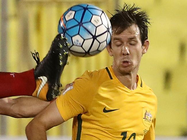 MALACCA, MALAYSIA - OCTOBER 05: Tamer Hag Mohamad of Syria challenges Robbie Kruse of Australia during the 2018 FIFA World Cup Asian Playoff match between Syria and the Australia Socceroos at Hang Jebat Stadium on October 5, 2017 in Malacca, Malaysia.  (Photo by Robert Cianflone/Getty Images)