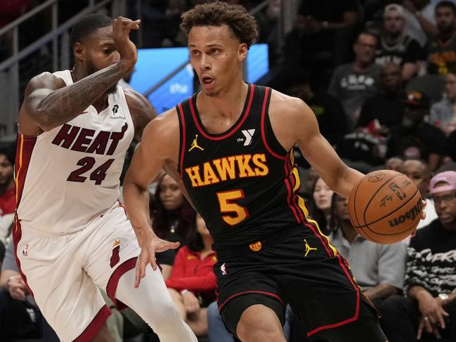 Atlanta Hawks guard Dyson Daniels (5) dribbles against Miami Heat forward Haywood Highsmith (24) in the first half of an NBA play-in tournament basketball game, Friday, April 18, 2025, in Atlanta. (AP Photo/Brynn Anderson)