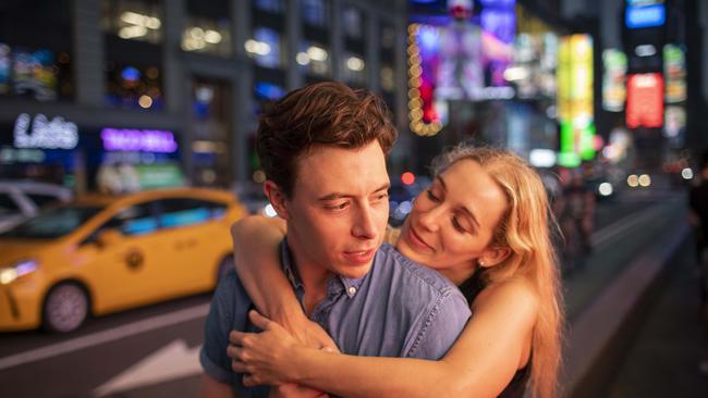 Phillip Mach, 31, and Elizabeth Roman, 33, both who live in the East Village pose in Times Square in Manhattan. Picture: Andrew Kelly