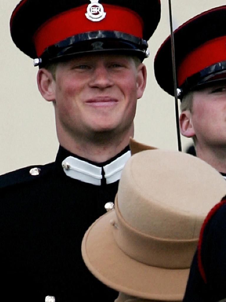 Prince Harry smiles as he speaks to his grandmother Queen Elizabeth II during the Sovereign's Parade at Sandhurst Military Academy. Picture: Carl de Souza / AFP.