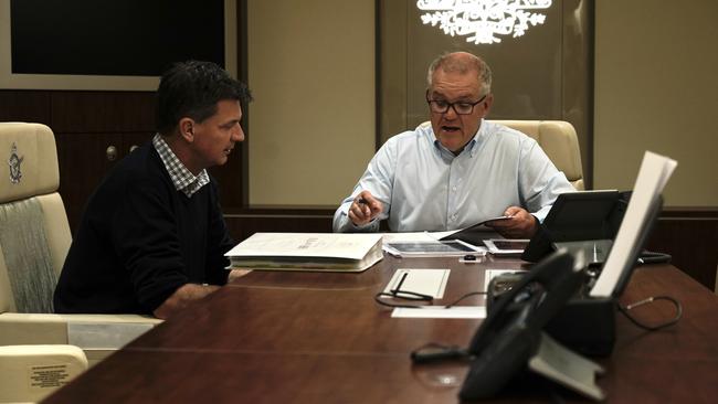 Prime Minister Scott Morrison and Energy Minister Angus Taylor chat in the boardroom ahead of the COP26 Climate summit in Glasgow. Picture: Adam Taylor/PMO