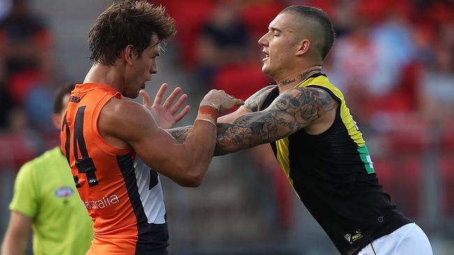 Richmond’s Dustin Martin fends off Giants Matt de Boer. Picture: Phil Hillyard