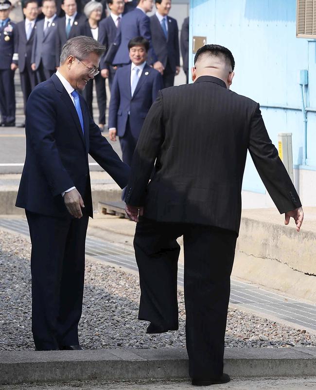 Kim crosses the military demarcation line to meet with Mr Moon. Picture: Korea Summit Press Pool/AP