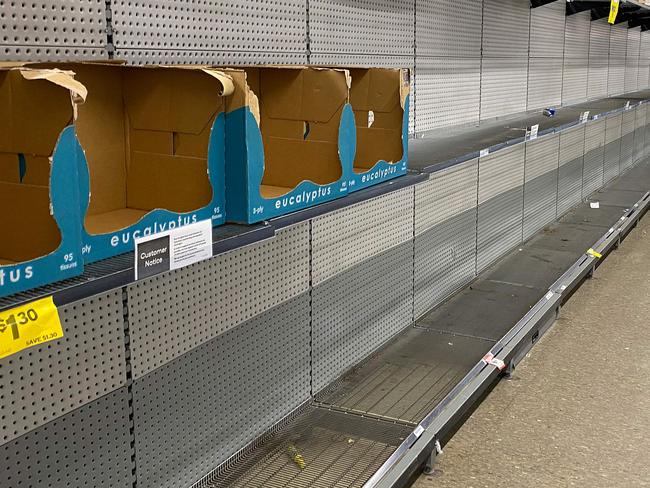 Shelves usually stocked with toilet rolls are seen empty in a supermarket following panic buying in Sydney on March 8, 2020. - A fight over toilet paper in an Australian supermarket on March 7 prompted police to call for calm after the latest violence sparked by coronavirus-induced panic buying in the country. (Photo by Saeed KHAN / AFP)