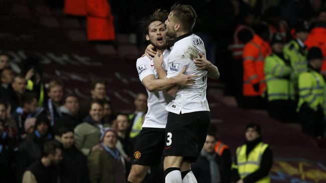 Manchester United's Dutch midfielder Daley Blind (L) celebrates.