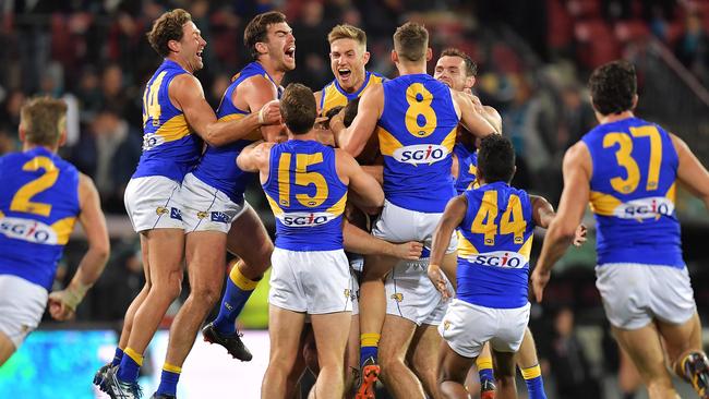 West Coast players celebrate the after-the-siren win. Picture: Getty