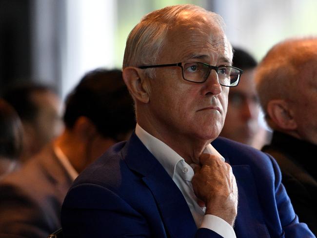 Former prime minister Malcolm Turnbull listens to New South Wales Energy Minister Don Harwin speak prior to delivering an address at the NSW Smart Energy Summit in Sydney, Tuesday, December 4, 2018. (AAP Image/Dan Himbrechts) NO ARCHIVING