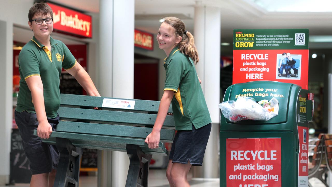 Woodville Primary students, Sally Thompson, 12, and Adrian Altus, 11, at the Welland Plaza shopping centre to collect their bench made from soft plastics recycled in the REDcycle program. Coles and Replas are donating the benches to schools around Australia.