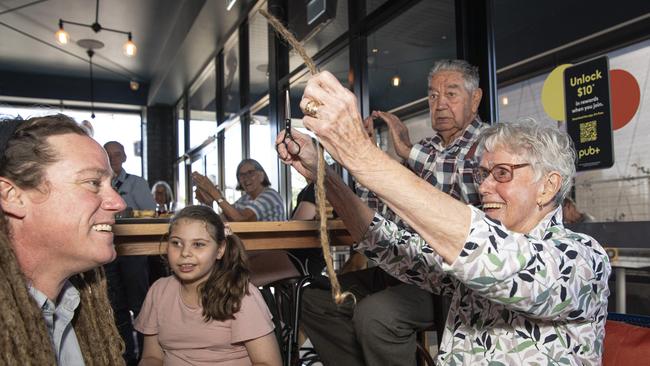 Joel Anderson's nana Maria Anderson makes the first cut as his dreadlocks come off in a fundraiser for daughter Charlise Anderson at the Blue Mountain Hotel, Saturday, November 23, 2024. Picture: Kevin Farmer