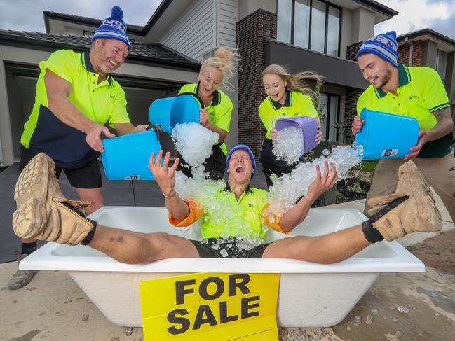 Tradies Rob Williams, Carolyn Hutchinson, Brittney Hutchinson and Rhys Reddaway throw ice on Broden Kruijer-Hall in the bath. Picture: Alex Coppel