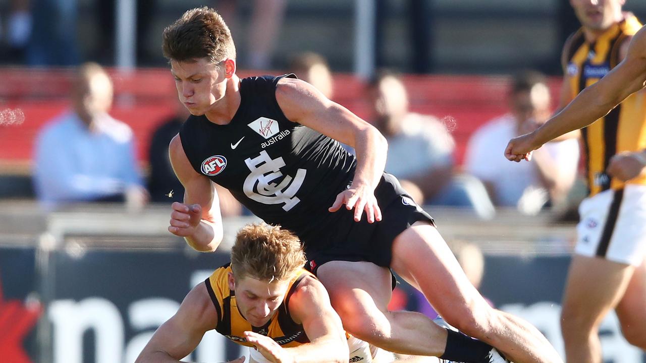 Sam Walsh and Dylan Moore compete for the ball. Photo: Scott Barbour/Getty Images.