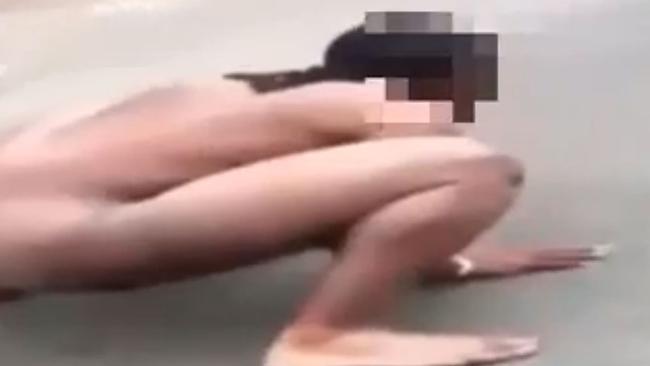 A naked man, high on K2, is filmed slapping the ground and making bizarre noises in the middle of a New York street.