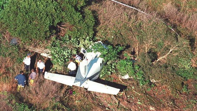 Emergency services inspect the wreckage of the aircraft crash at Sunshine Coast Airport. Dr Richard Heath and Gerry Geltch were in the plane, in 2001.