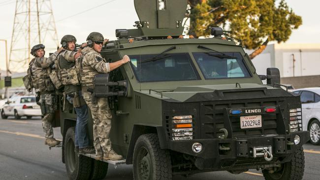 Authorities search an area ... near where police stopped a suspected vehicle in San Bernardino. Picture: AP