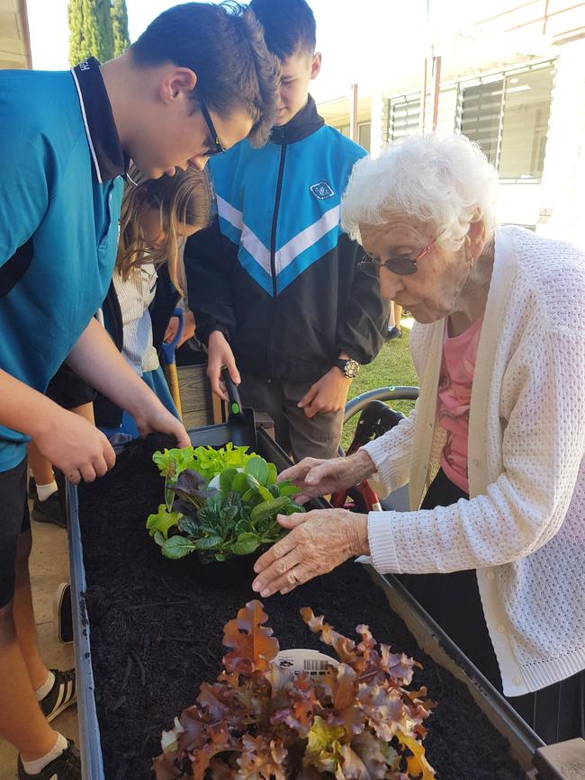 Laidley State High School student Luke Brady and Carinity Karinya Place resident Elsie Pomerenke tend to a plant. Photo: Supplied