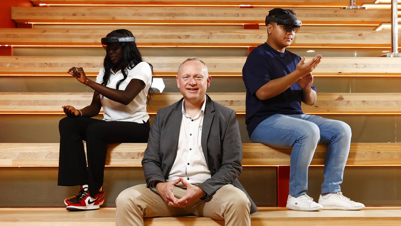 Kirk Duncan, CEO of The Mobile Apps Man, with the Microsoft HoloLens with medical science student Mary Bul and information and communication technology student Don Caspillo. He’s among the new start-ups forging ahead in Parramatta. Picture: Richard Dobson