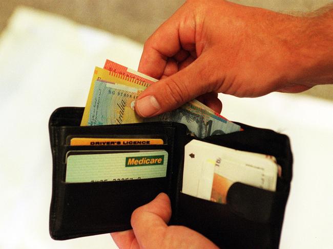 Mar 03, 2000 : Generic photo of man removing money from his wallet - notes Australian currency hand medicare card