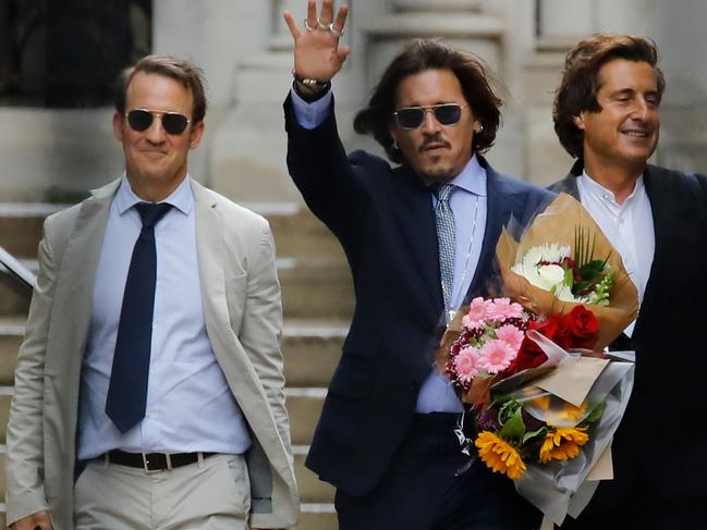 US actor Johnny Depp carries flowers as he leaves the court. Picture: AFP