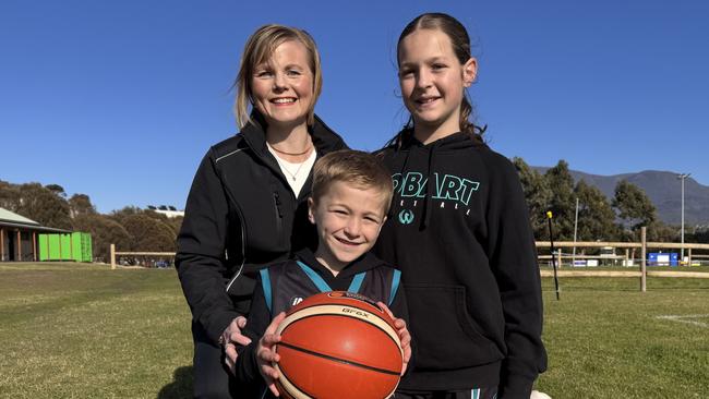 Bec Thomas (MLC) with basketball juniors Jack Tringrove, 7, and his sister Matilda Tringrove, 12, at New Town Bay. Picture James Bresnehan