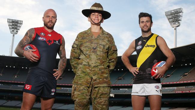 Melbourne skipper Nathan Jones and Richmond captain Trent Cotchin with Sergeant Rhi Busch ahead of the Anzac eve game. Picture: Michael Klein