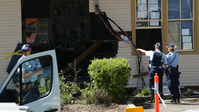 Police inspect the gutted classroom. Two boy were killed in the crash. Picture: Jonathan Ng