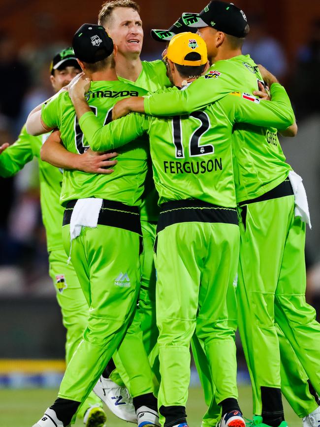 Sydney Thunder players celebrate their thrilling three-run triumph against the Strikers. Picture: Daniel Kalisz/Getty Images