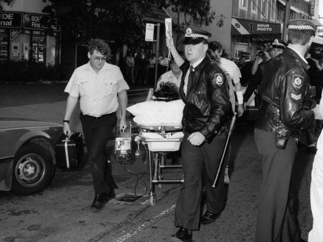 An injured person is led away during the massacre.