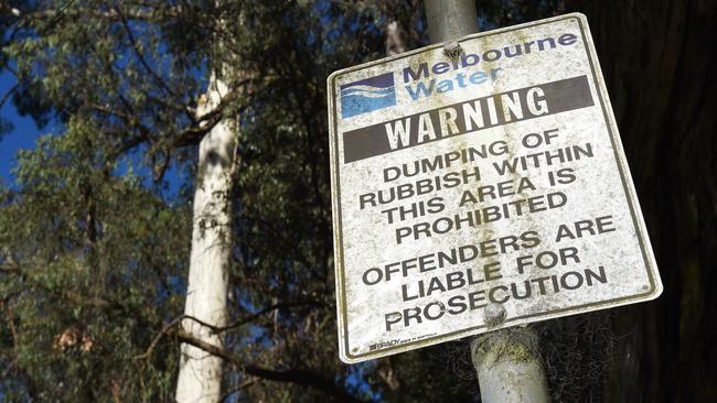 A sign at the Yarra River site prohibiting rubbish dumping and threatening legal action. Picture: Steve Tanner