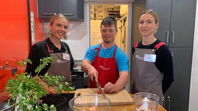 CROSS CHOPPING KING: Tarron George working his magic in the kitchen, with Jamie Oliver's Ministry of Food nutritionists and kitchen managers, Bridget Horsey and Lexi Costello. Picture: Rhylea Millar