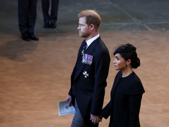 Prince Harry and Meghan, Duchess of Sussex walk as procession with the coffin of Britain's Queen Elizabeth arrives at Westminster Hall from Buckingham Palace for her lying in state. Picture: Phil Noble – WPA Pool/Getty Images