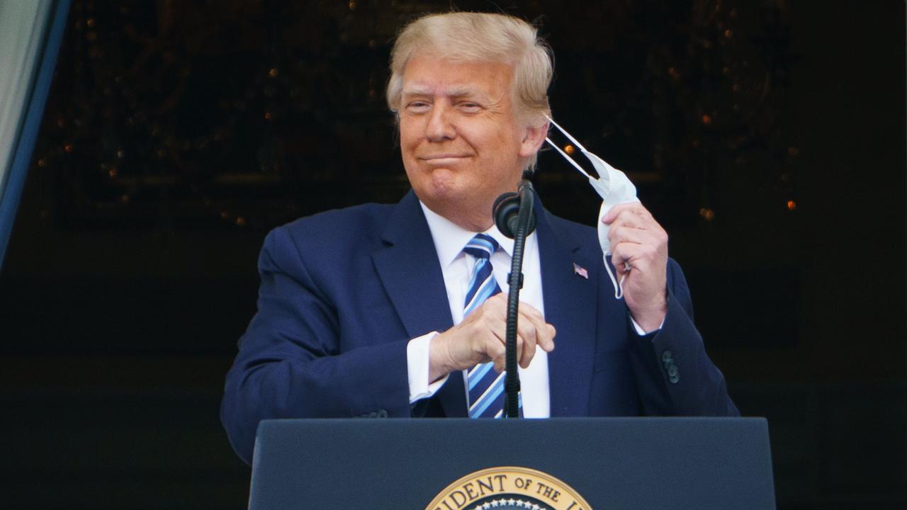 Donald Trump takes his mask off before speaking from the South Portico of the White House. Picture: Mandel Ngan/AFP