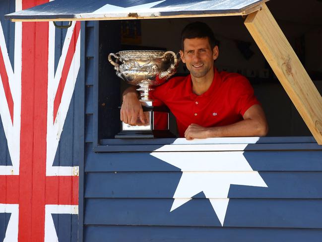 Serbia's Novak Djokovic poses with the Norman Brookes Challenge Cup trophy during a photo shoot at the Brighton Beach in Melbourne, in happier times. Picture: AFP