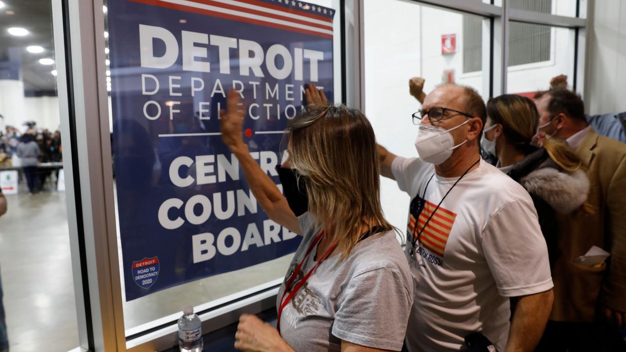 Supporters of US President Donald Trump bang on the glass and chant slogans outside the room where absentee ballots for the 2020 general election are being counted in Detroit, Michigan. Picture: Jeff Kowalsky/AFP