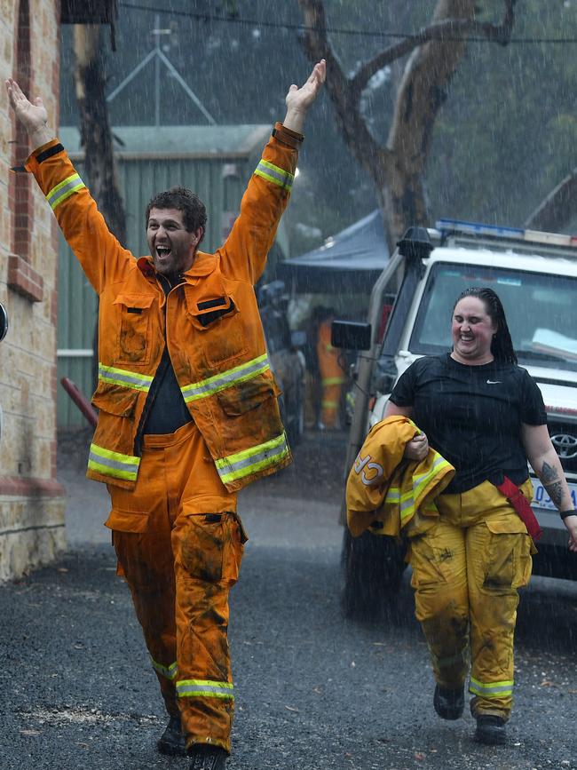 CFS volunteers celebrate the rain providing relief to the Cherry Gardens fire. Picture: Tom Huntley