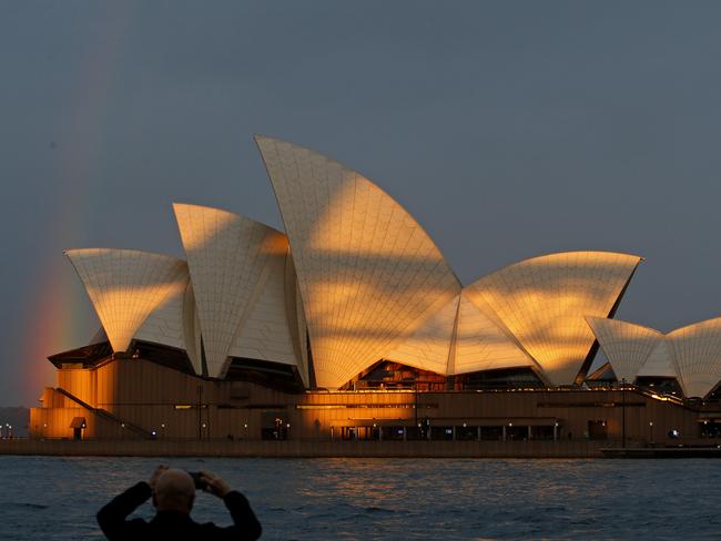 SYDNEY, AUSTRALIA - NewsWire Photos MAY 23 , 2025:Taking a photo of  the rainbow over the Opera House in the fading afternoon light on the  Opening Night of Vivid Sydney.   Picture: NewsWire / John Appleyard
