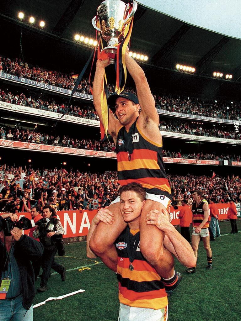 Mark Bickley carries Andrew McLeod on his shoulders after their 1998 back-to-back premiership win. Picture: Files