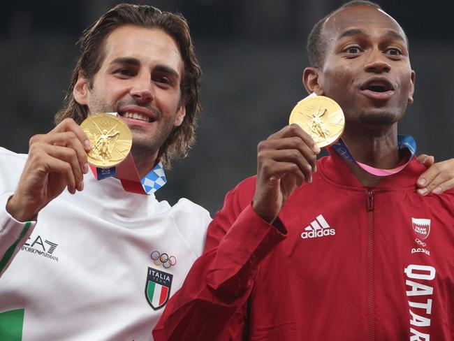 TOKYO, JAPAN - AUGUST 02: Joint gold medalists Mutaz Essa Barshim of Team Qatar and Gianmarco Tamberi of Team Italy celebrate on the podium during the medal ceremony for the Men's High Jump on day ten of the Tokyo 2020 Olympic Games at Olympic Stadium on August 02, 2021 in Tokyo, Japan. (Photo by Patrick Smith/Getty Images)