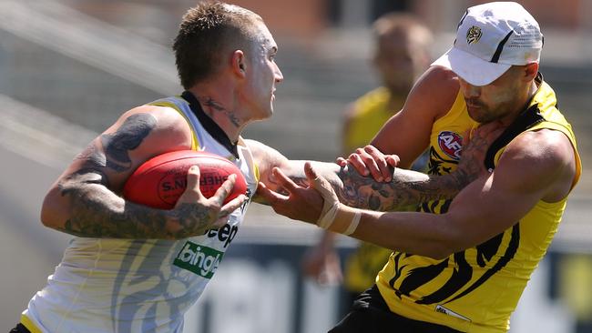 Dustin Martin fends off Shaun Grigg at training. Picture: Wayne Ludbey