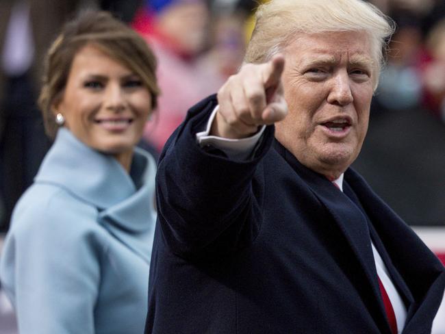 President Donald Trump, accompanied by first lady Melania Trump, points to members of the crowd as they walk in his inaugural parade on Pennsylvania Ave. outside the White House in Washington, Friday, Jan. 20, 2017. (AP Photo/Andrew Harnik)