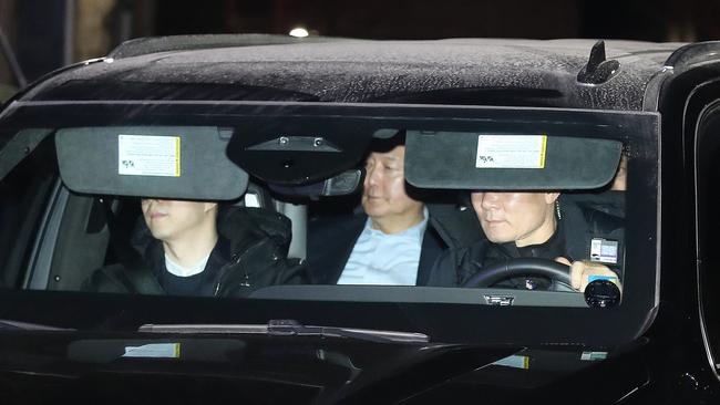 Impeached South Korean President Yoon Suk Yeol, centre, leaves for the Seoul detention centre on Wednesday night. Picture: Getty Images