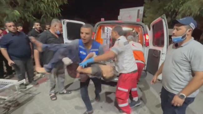 Palestinian rescuers carrying an injured youth at a hospital after a strike at the Osama bin Zaid school, which shelters displaced people in the Saftawi area, north of Gaza City on November 3, 2023. Picture: AFP