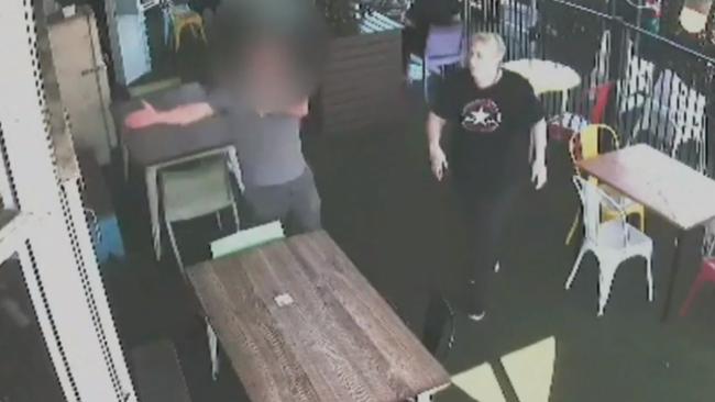 Shocking CCTV shows the moment a customer loses it at cafe staff and allegedly begins throwing plates after being told of a public holiday surcharge. Picture: CH9