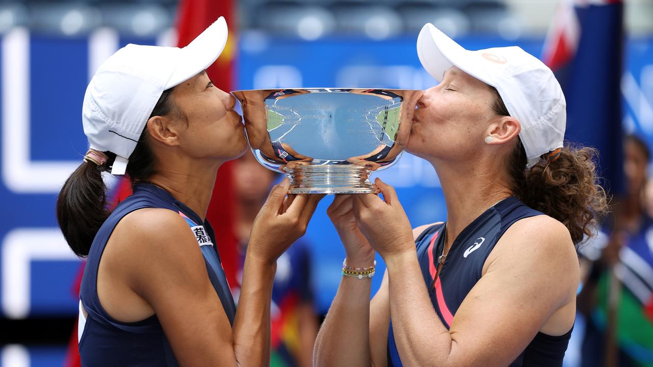 Shuai Zhang of China and Samantha Stosur of Australia and celebrate with the championship trophy