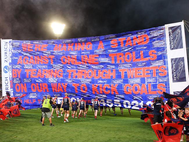 MELBOURNE, AUSTRALIA - APRIL 05: Social media texts from trolls are seen on the demons banner during the round three AFL match between the Melbourne Demons and the Essendon Bombers at Melbourne Cricket Ground on April 05, 2019 in Melbourne, Australia. (Photo by Michael Dodge/Getty Images)