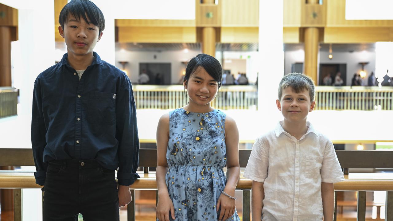The three national champions (from left) Zachary Cheng (Years 7-8), Abigail Koh (Years 5-6) and Samuel Wright (Years 3-4) wait to see the Prime Minister in Canberra. Picture: NCA NewsWire/Martin Ollman
