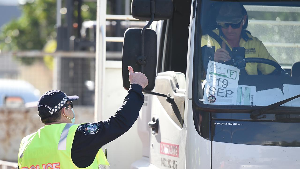 Police speak with a truck driver at the Queensland border with NSW. Picture: Getty Images