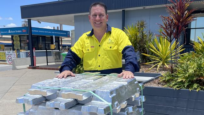 Gladstone Mayor Matt Burnett behind a stack of aluminum ingots at the Rio Tinto Boyne smelter.