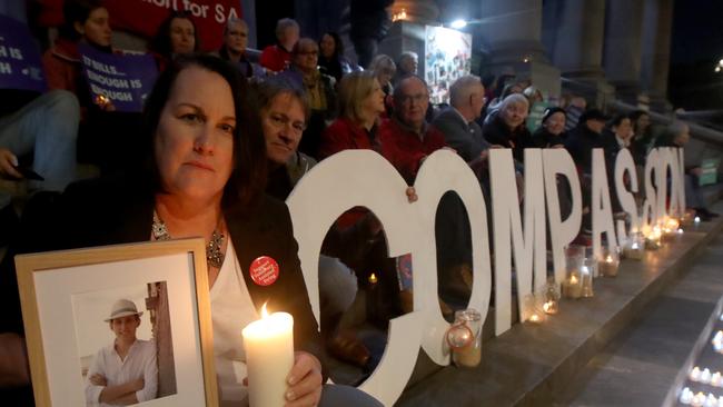 Liz and Brett Habermann holds a photo of her son Rhys, who took his own life to due illness at a euthanasia vote vigil on the steps of Parliament House, Adelaide. Picture: Kelly Barnes