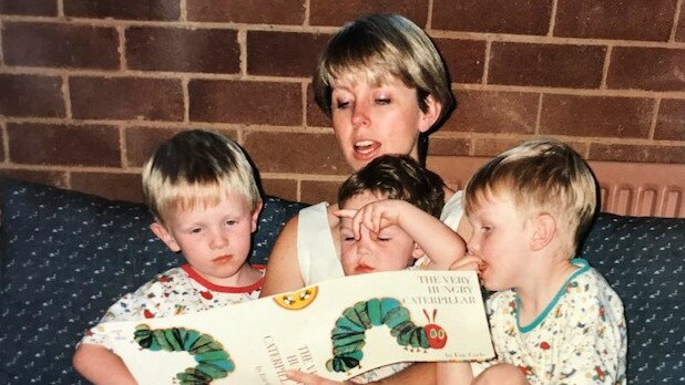 Zachary Rolfe, centre, with his mother Deborah and older brothers.